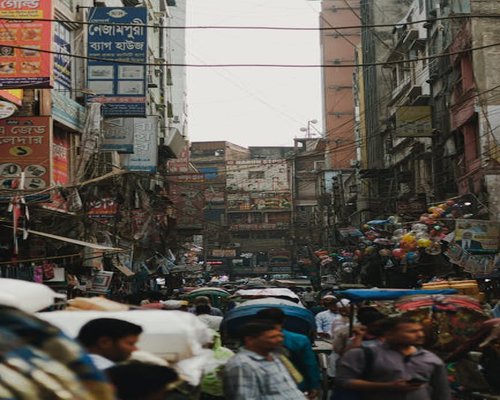 People walking on a busy street in Dhaka