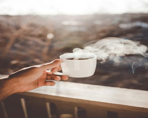 A person holding a cup of coffee